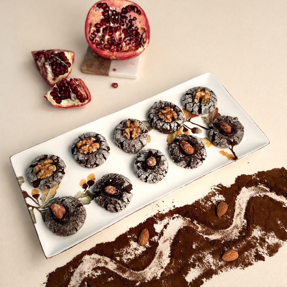 Crackle-topped chocolate cookies finished with walnuts and almonds on a white tray, Honey & Fig Bakery, Pflugerville, Texas